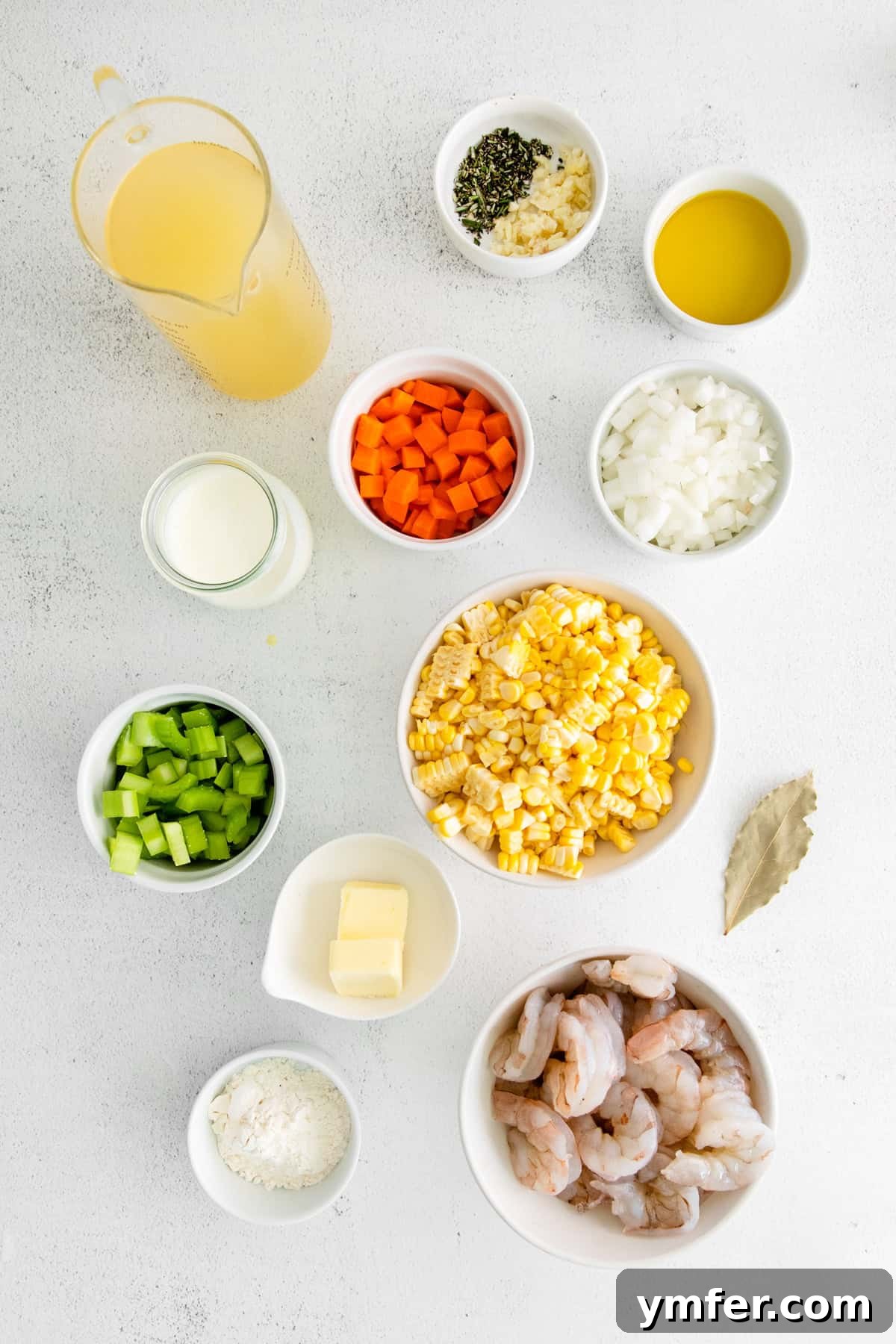 Golden Harvest Shrimp and Corn Chowder 3 Fresh ingredients for Shrimp Corn Chowder laid out on a wooden table, including shrimp, corn, herbs, and various vegetables.