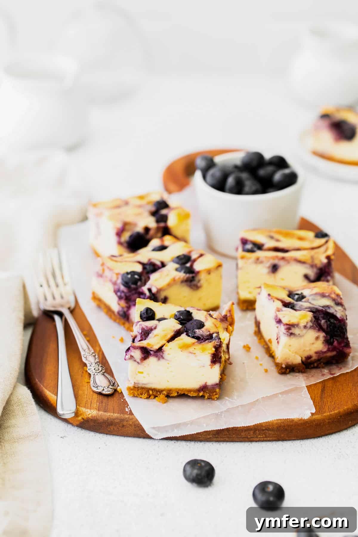 Luscious Blueberry Cheesecake Bars 7 Perfectly cut blueberry cheesecake bars, ready for serving, showing the distinct layers of crust and filling.