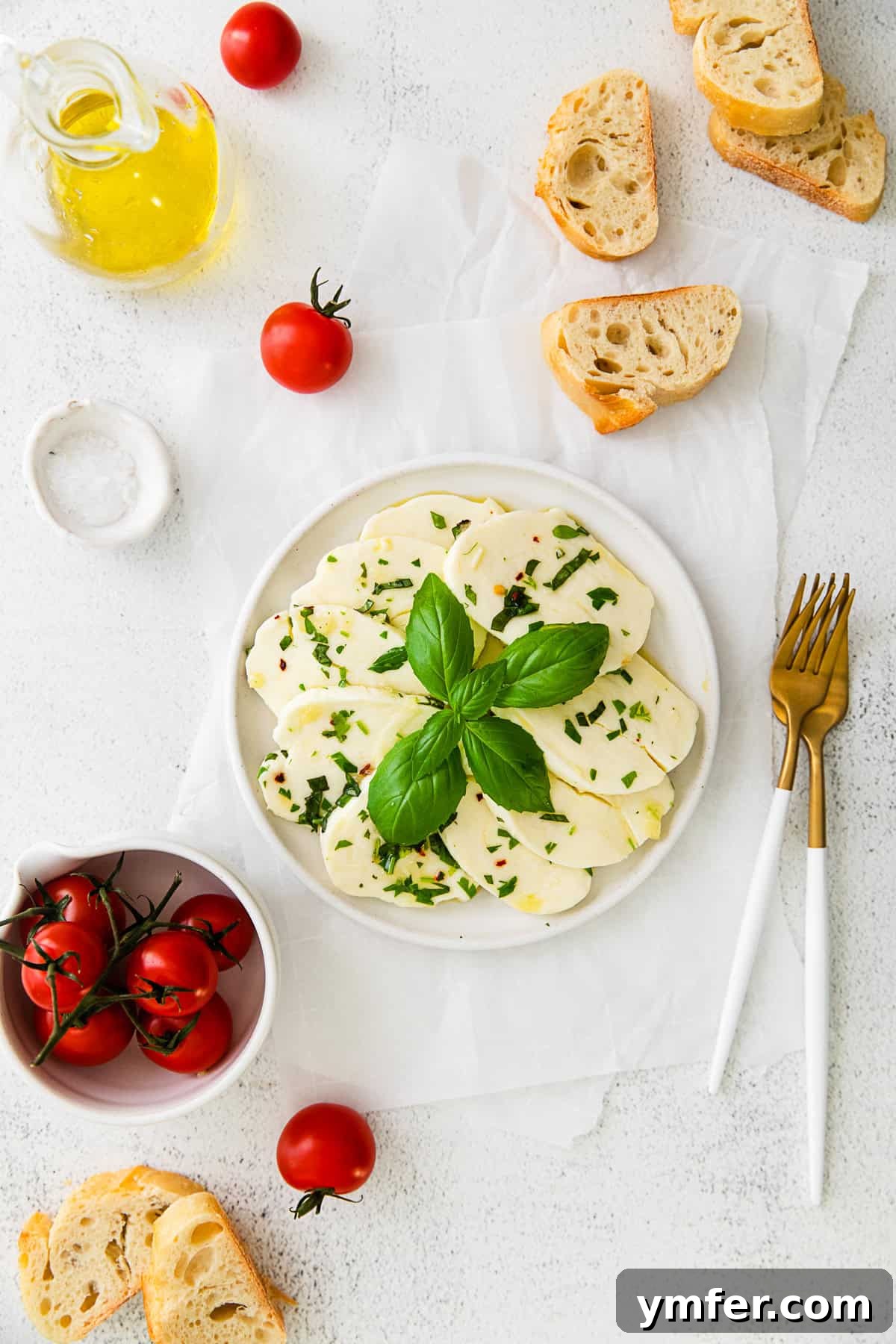 Flavorful Mozzarella Delights 2 Marinated Mozzarella on a plate with forks and bread.