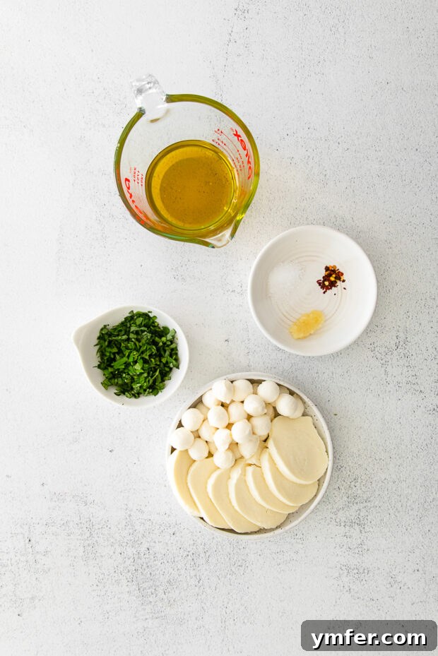 Flavorful Mozzarella Delights 3 Ingredients to make Marinated Mozzarella on a table.