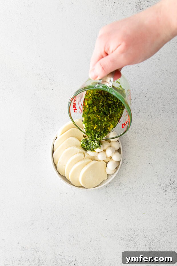 Flavorful Mozzarella Delights 4 Pouring olive oil and herbs over mozzarella cheese.