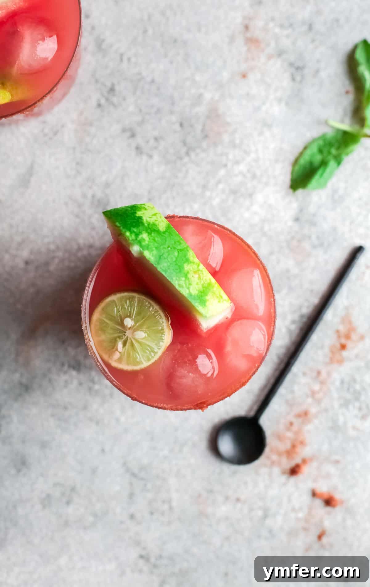 Blush Paloma 6 Watermelon Paloma in a glass garnished watermelon and lime.