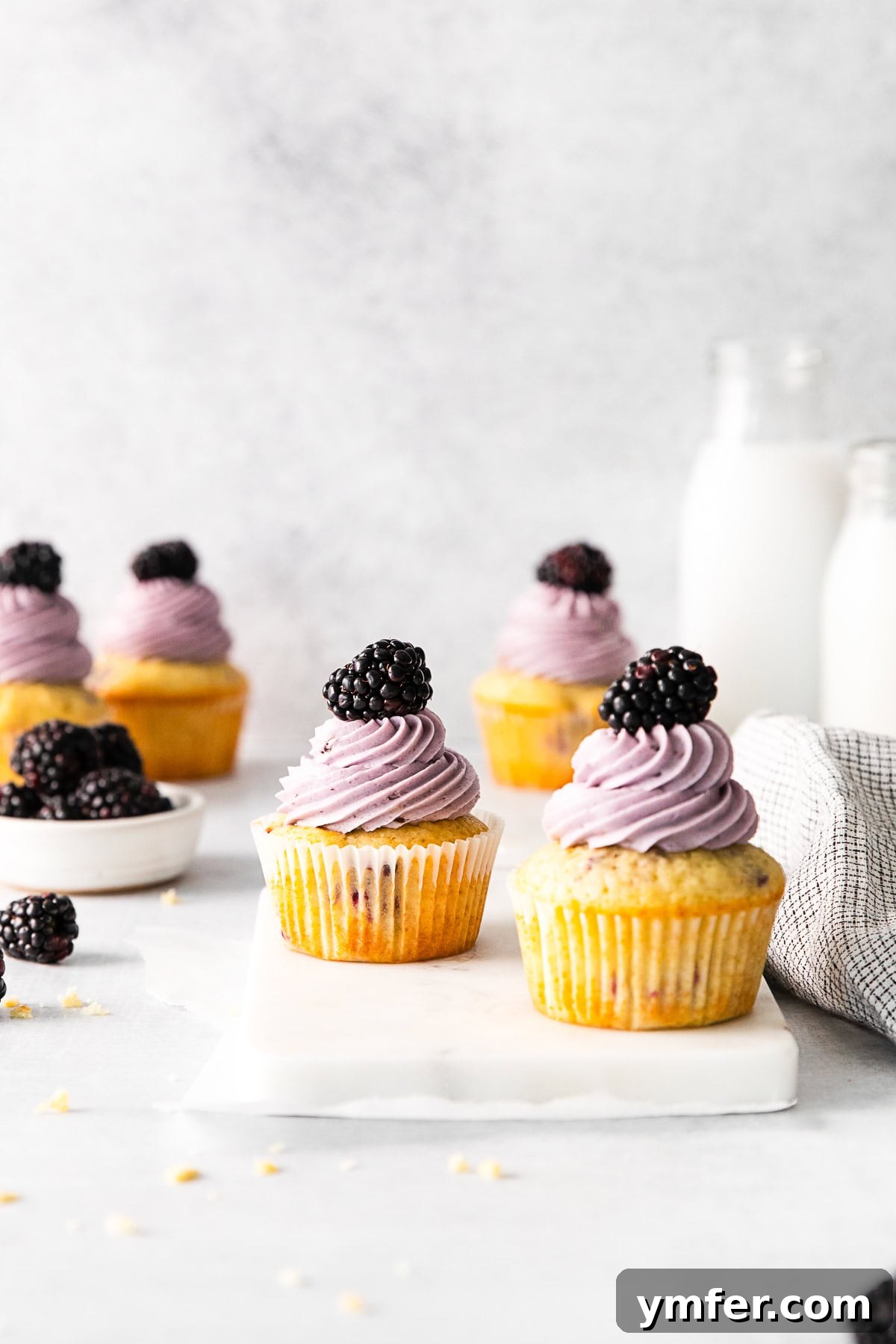Blackberry Bramble Cupcakes 8 Beautifully frosted Blackberry Cupcakes arranged on a white serving tray, ready to be enjoyed.