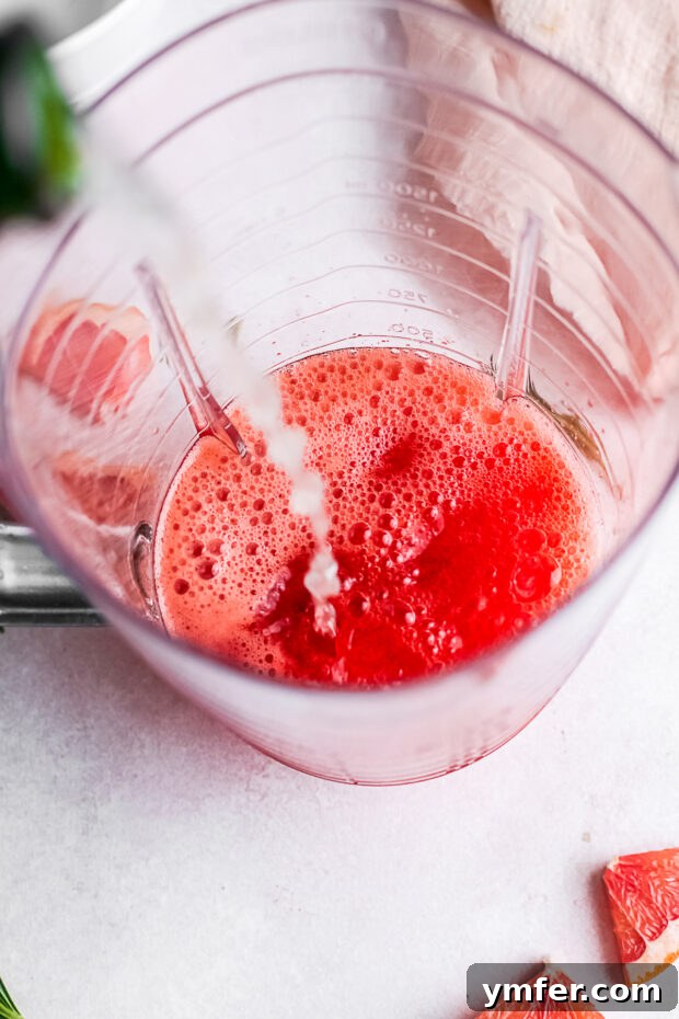 Slushy Aperol Bliss 4 Prosecco being poured into a blender.