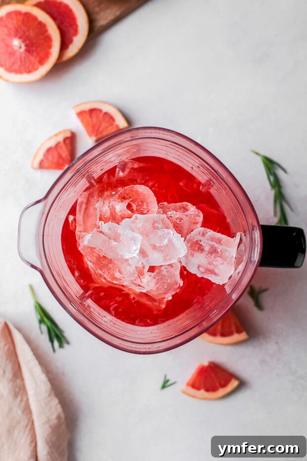 Slushy Aperol Bliss 5 A blender filled with alcohol and ice.