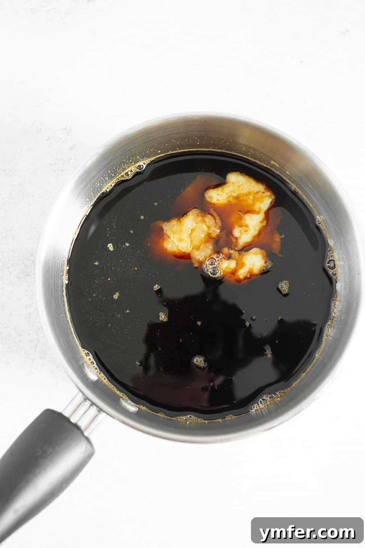 Simple Homemade Teriyaki 4 Teriyaki sauce simmering and thickening in a pot on the stovetop.