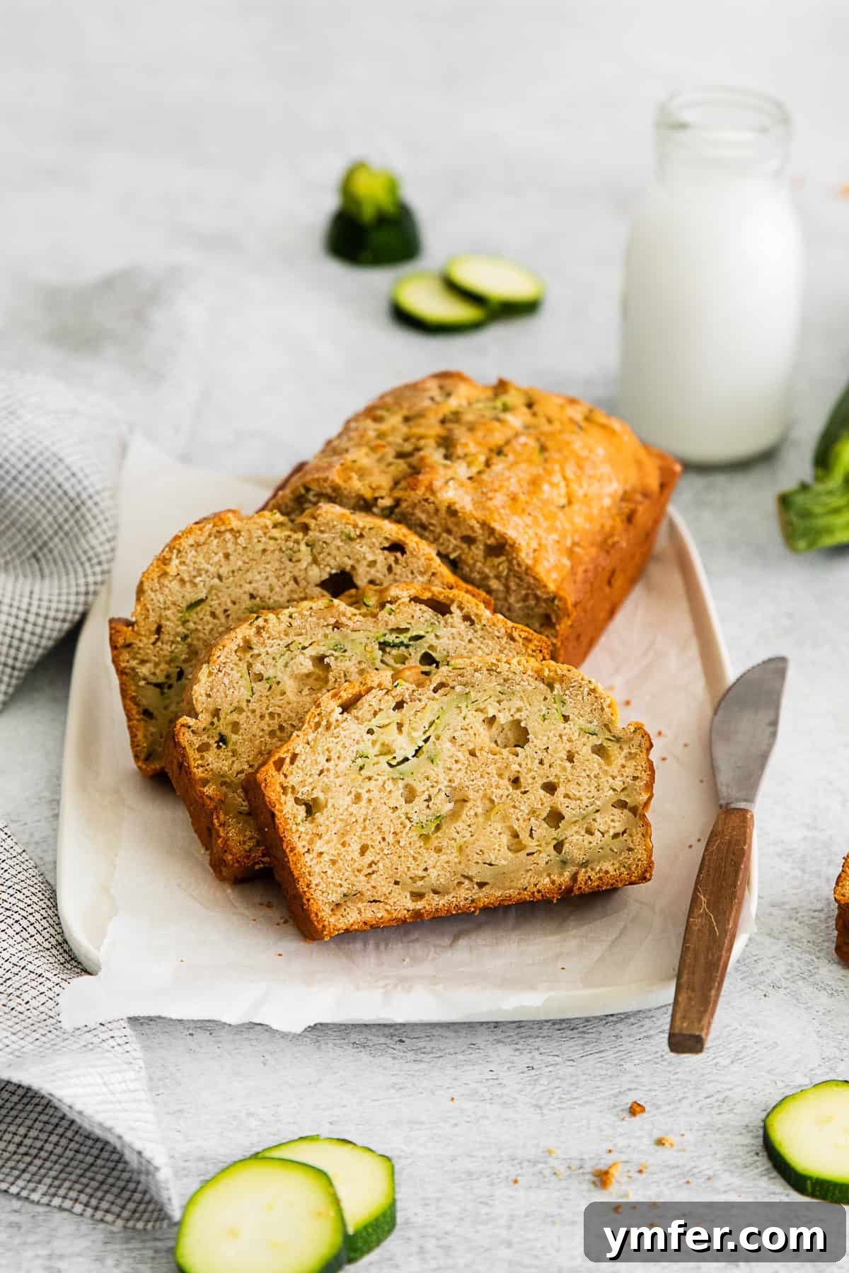 Zucchini Bread served with a knife for slicing. 