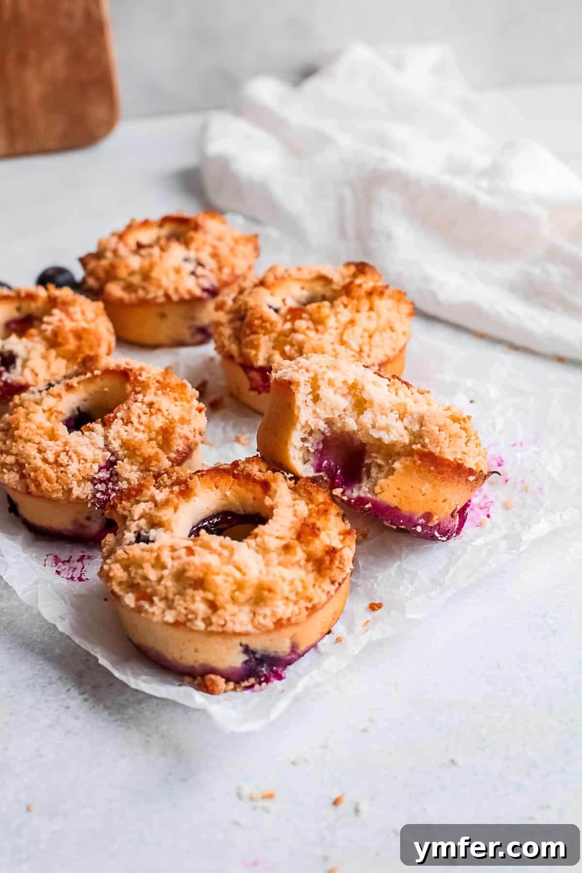 Close-up of Baked Blueberry Streusel Donuts topped with a golden, crunchy streusel.