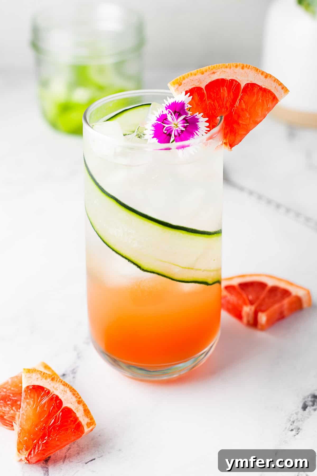 Grapefruit Gin Sparkler 6 A beautifully garnished Grapefruit Gin Fizz with an edible flower, highlighting its elegance.