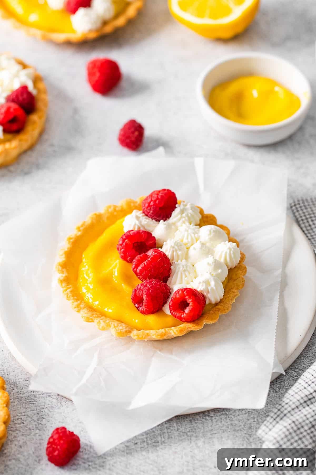 Sunshine Lemon Tarts 9 Lemon Curd Tarts cooling on parchment paper, highlighting their golden crusts and smooth filling.