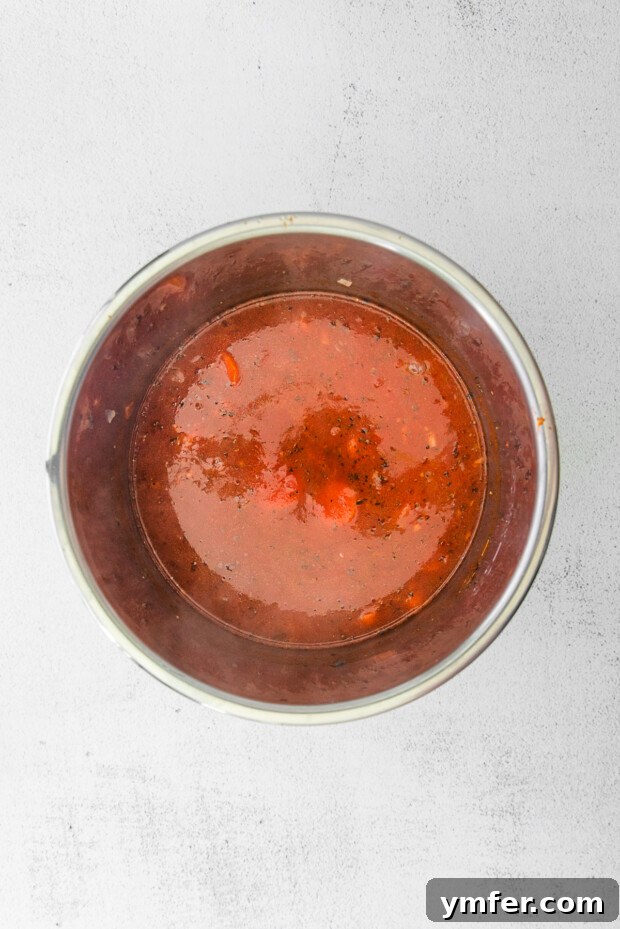 Effortless Instant Pot Tomato Delight 5 tomato soup in an instant pot. A rich, red tomato soup base is simmering inside an Instant Pot, before the addition of cream or blending.