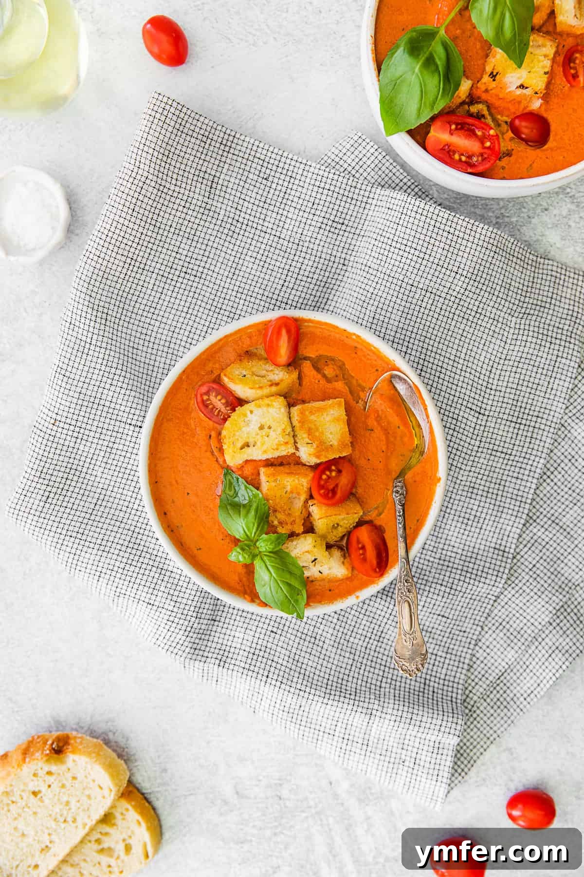 Effortless Instant Pot Tomato Delight 8 Instant Pot Tomato Soup topped with croutons. A white bowl filled with creamy Instant Pot Tomato Soup, generously topped with golden croutons, captured from an overhead angle.