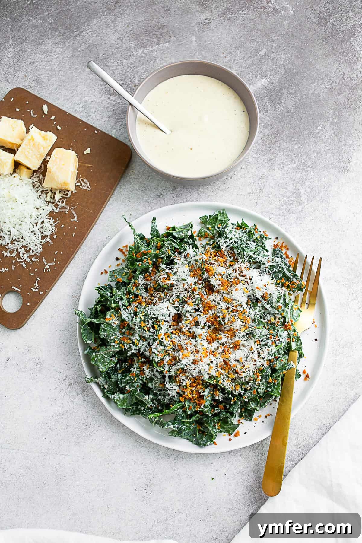 Zesty Chopped Kale Caesar 2 Chopped Kale Caesar Salad on a white plate with a gold fork.