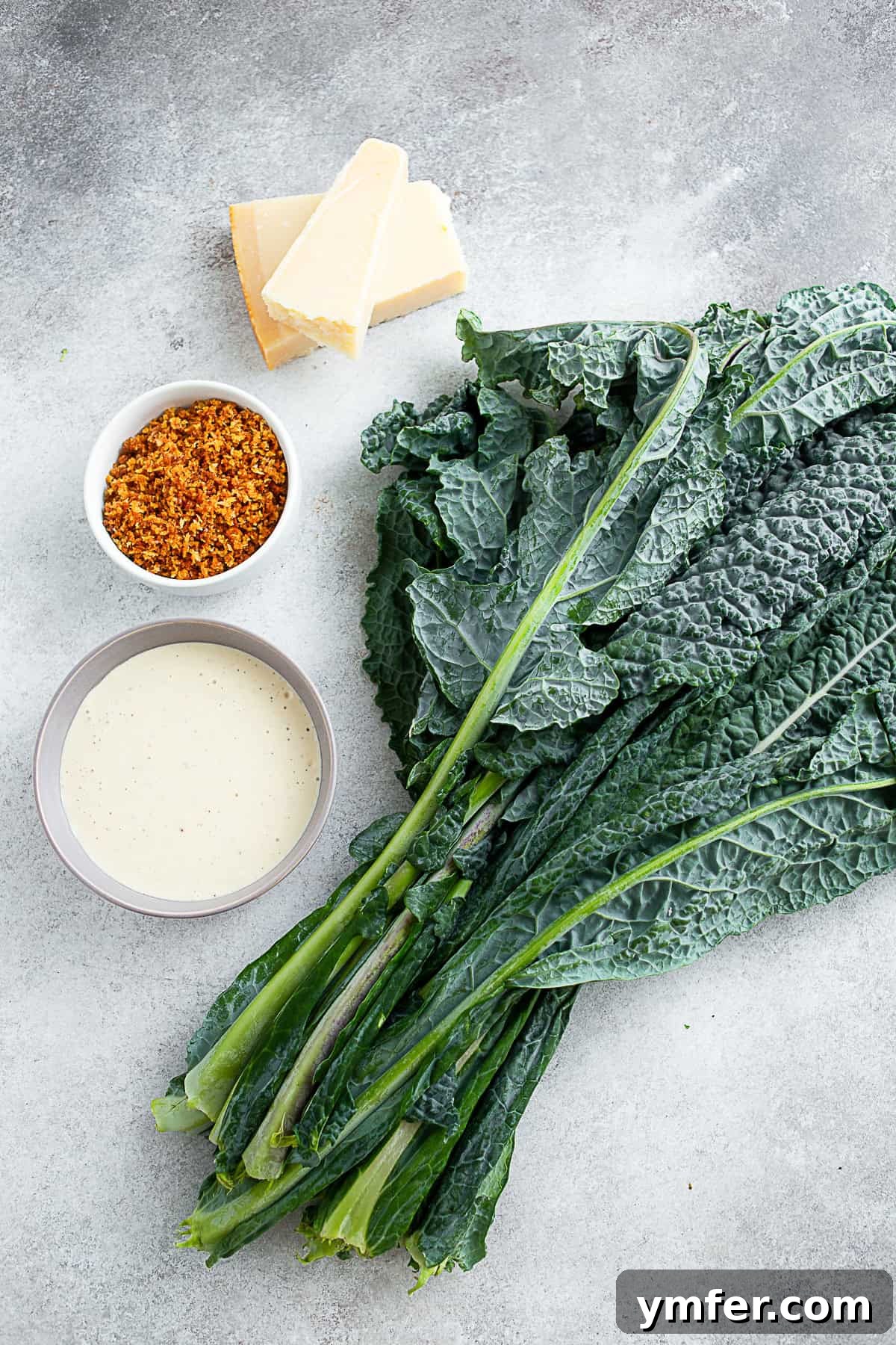 Zesty Chopped Kale Caesar 3 Lacinato kale, Caesar dressing, and toasted panko sitting on a table.