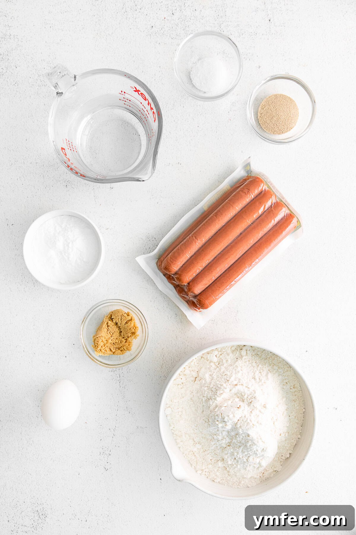 Golden Pretzel Franks 3 A collection of fresh ingredients laid out on a table, ready for making homemade pretzel dogs.