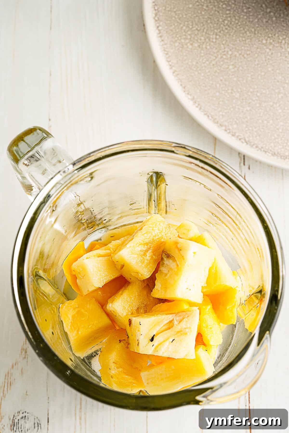 Tropical Mango Pineapple Bliss 4 Frozen pineapple and mango chunks ready to be blended for a tropical smoothie.