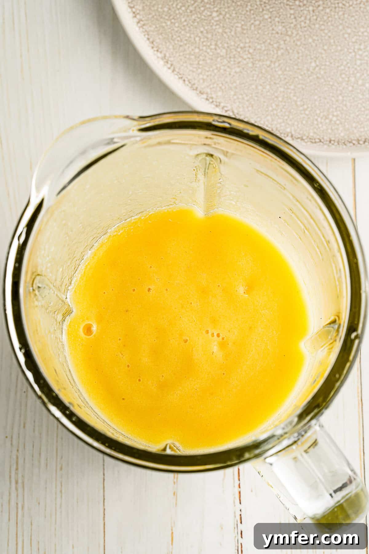 Tropical Mango Pineapple Bliss 5 Mango Pineapple Smoothie ingredients blending smoothly in a high-speed blender.