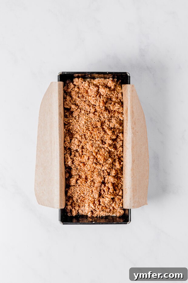 Spiced Apple Streusel Loaf 5 Apple Streusel Bread baking in a loaf pan, with streusel topping visible on top.