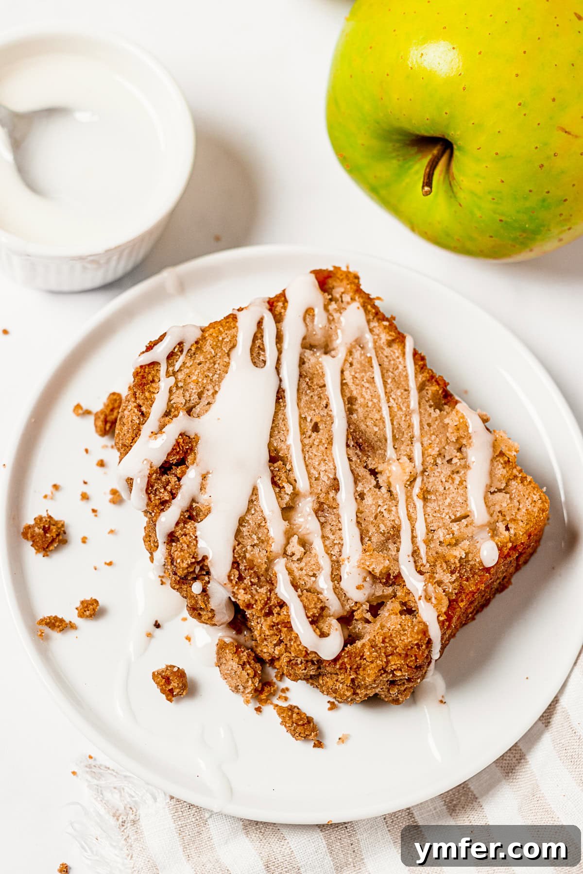 Spiced Apple Streusel Loaf 7 Sliced Apple Streusel Bread generously drizzled with a sweet vanilla glaze.