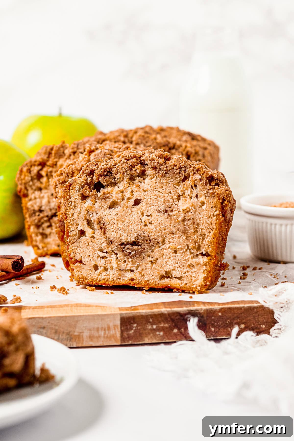 Spiced Apple Streusel Loaf 6 Apple Streusel Bread sliced to show its layers of moist bread and streusel, with visible apple chunks.