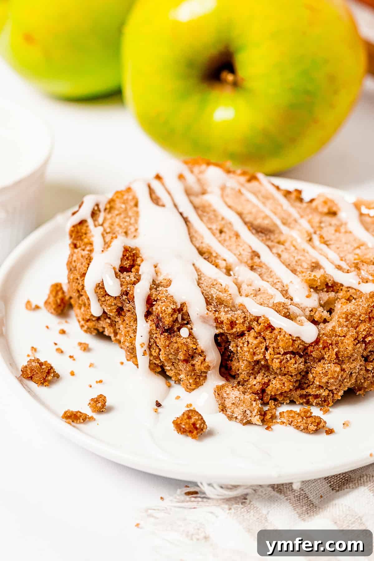 Spiced Apple Streusel Loaf 8 Close-up of Apple Streusel Bread with a generous drizzle of glaze, ready to be served.