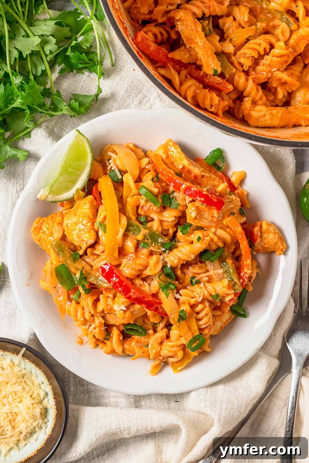 Zesty Skillet Chicken Fajita Pasta 6 One Pot Chicken Fajita Pasta served on a plate, garnished with fresh cilantro.