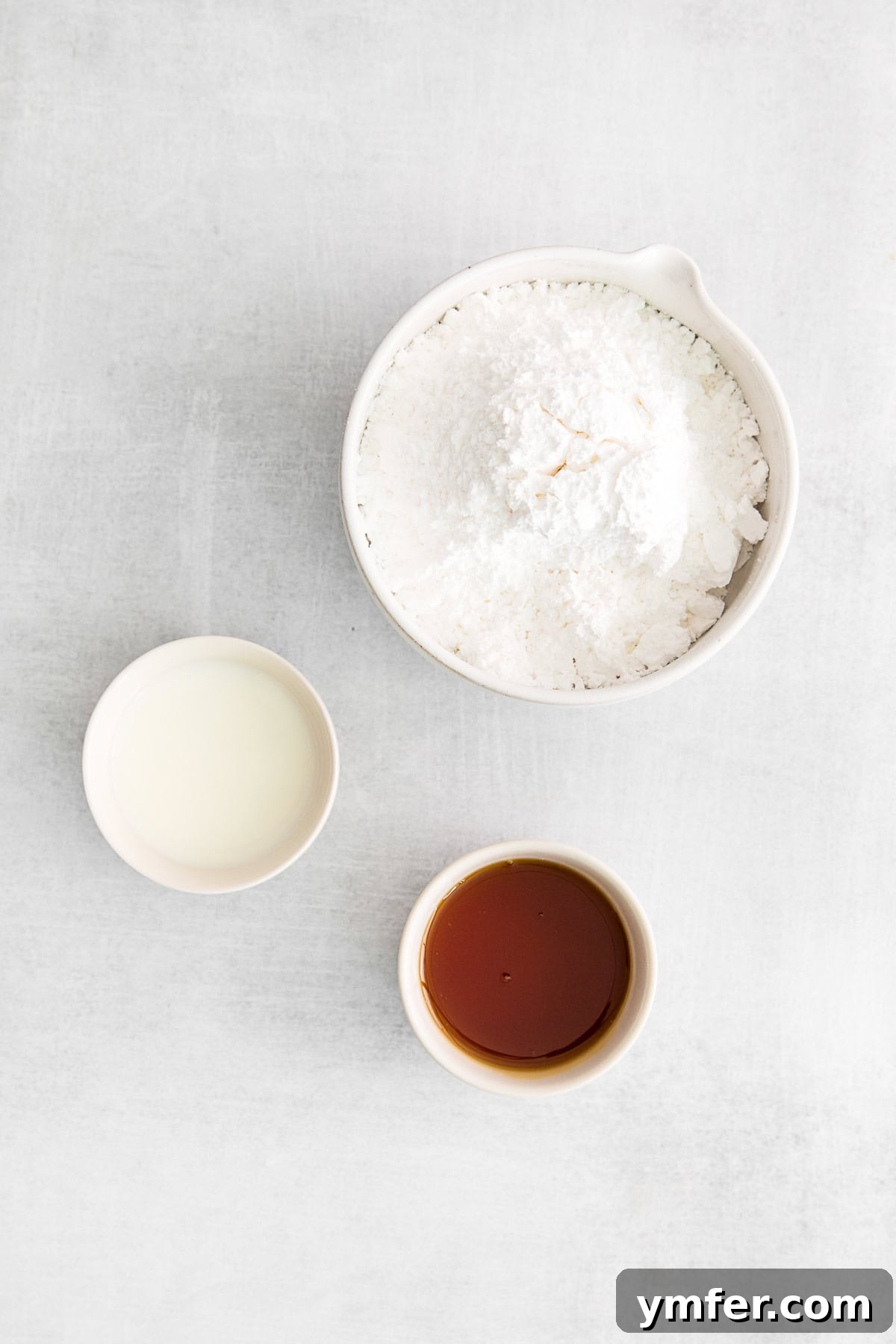 Maple Drizzle Delights 4 Ingredients arranged to make maple icing, including powdered sugar, maple syrup, and milk.