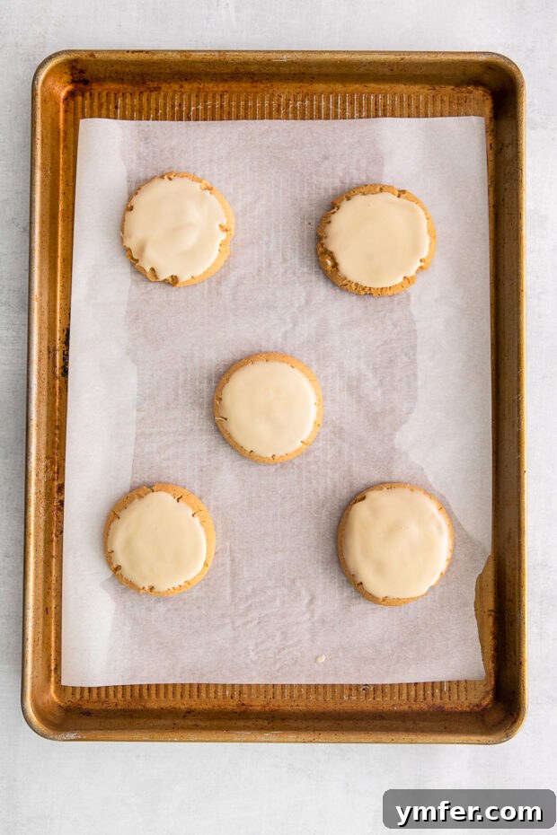 Maple Drizzle Delights 6 A closer view of baked maple cookies cooling on a wire rack, ready for glazing.