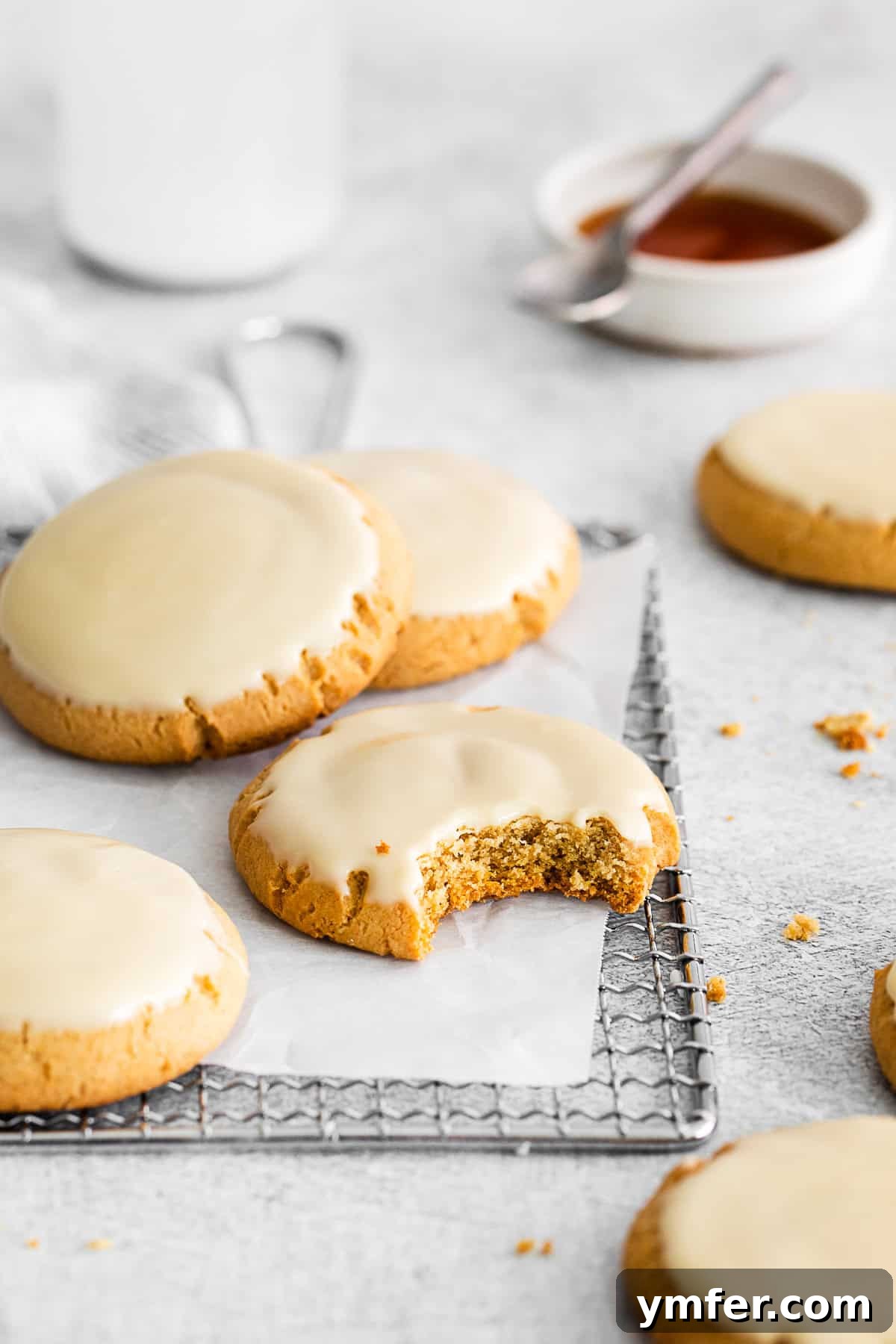 Maple Drizzle Delights 7 A maple glazed cookie with a bite taken out, revealing its soft and chewy interior.