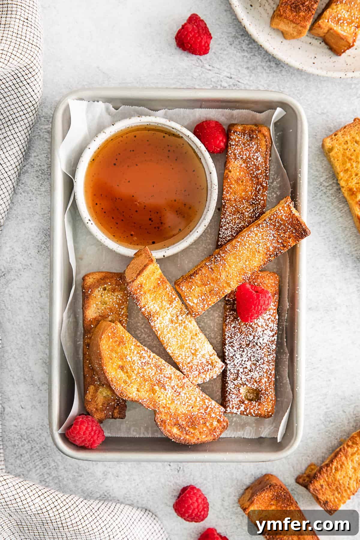 Crispy Air Fryer French Toast Sticks elegantly arranged on a rustic metal tray, ready to be served for a delicious breakfast.