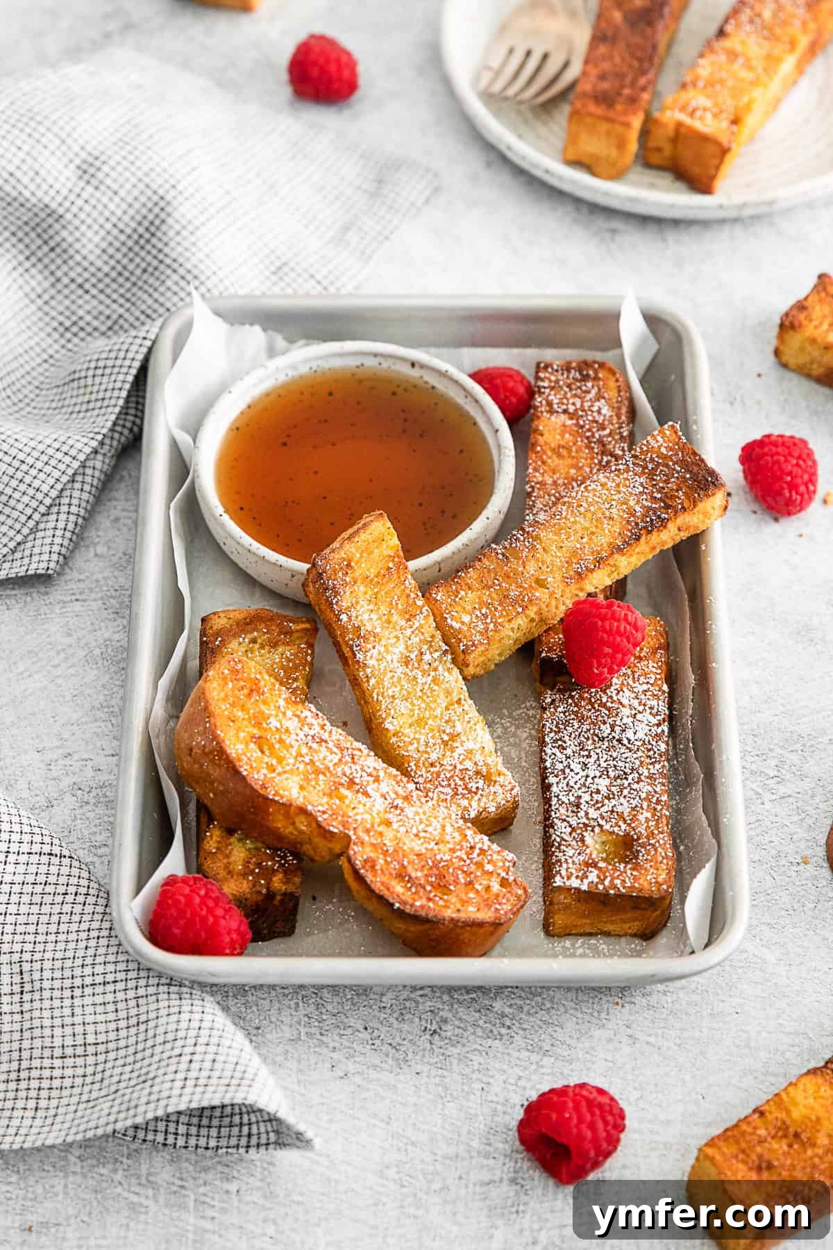 A bounty of golden Air Fryer French Toast Sticks piled high on a serving tray, perfect for a family breakfast or brunch.