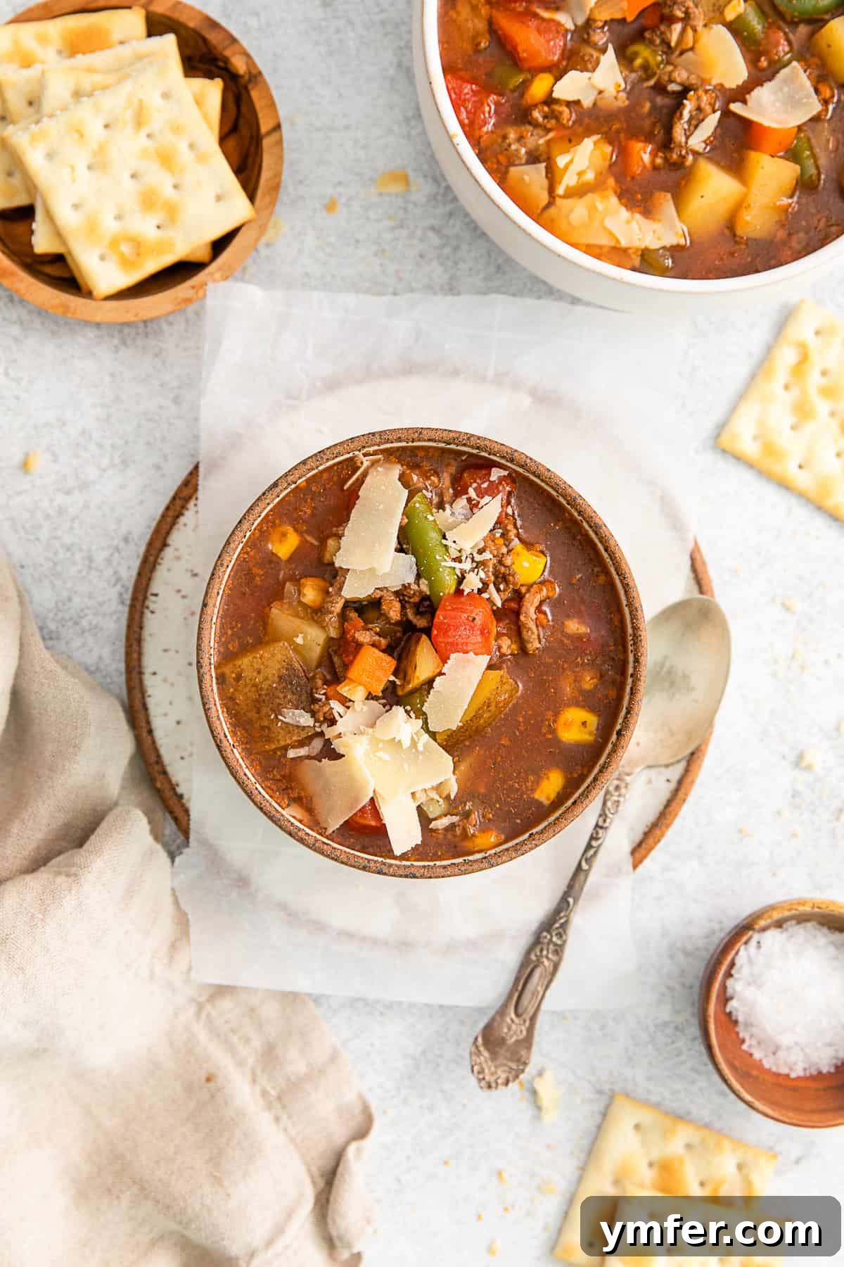 Beef Vegetable Soup 7 Vegetable Beef Soup topped with a generous sprinkle of parmesan cheese.