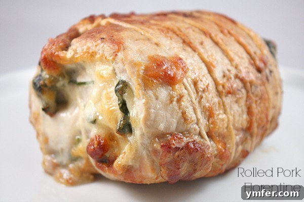 Rolled Pork Florentine on a white plate. 