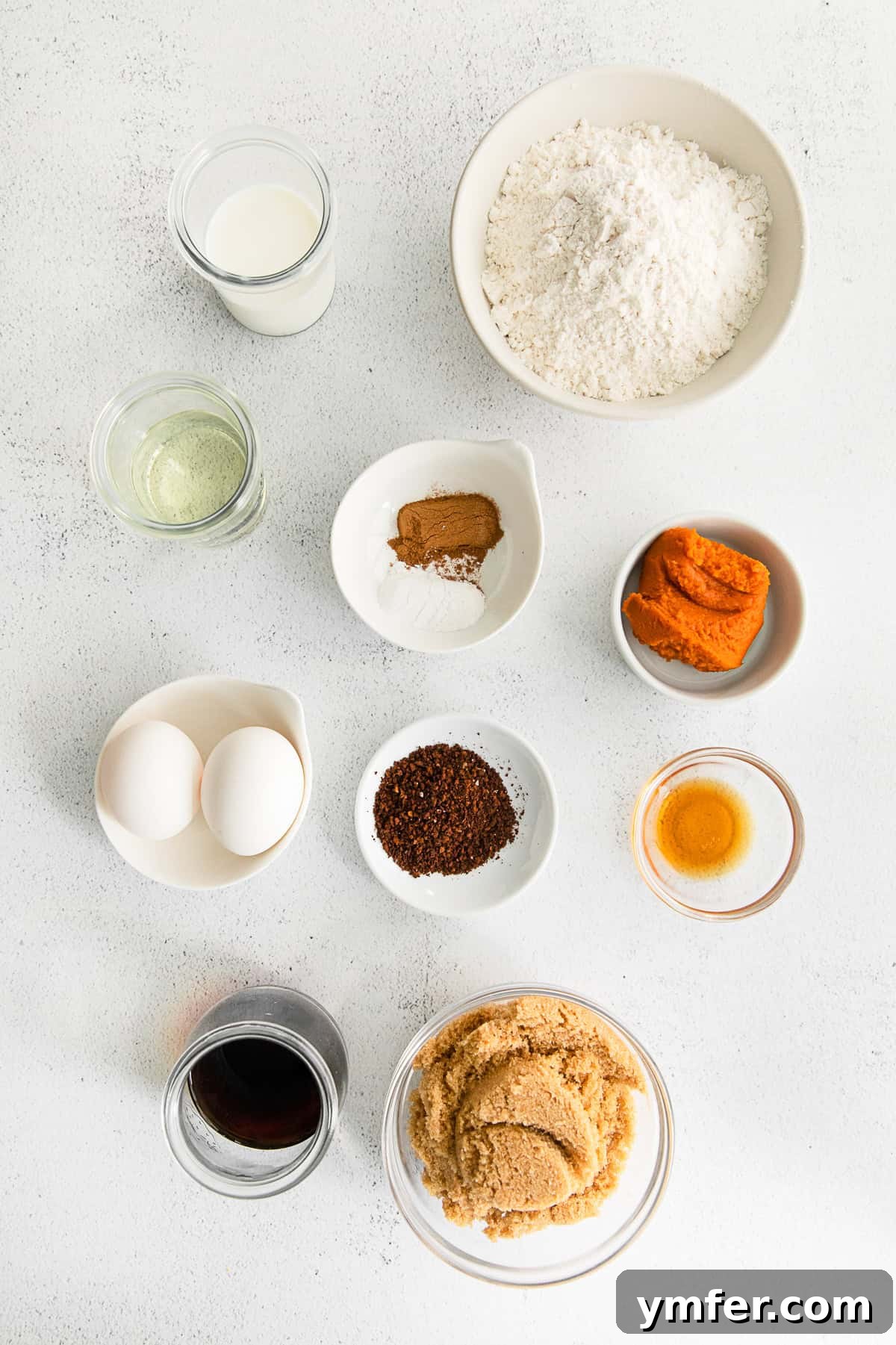 A collection of fresh ingredients laid out on a table, ready for baking delicious Pumpkin Spice Latte Cupcakes.