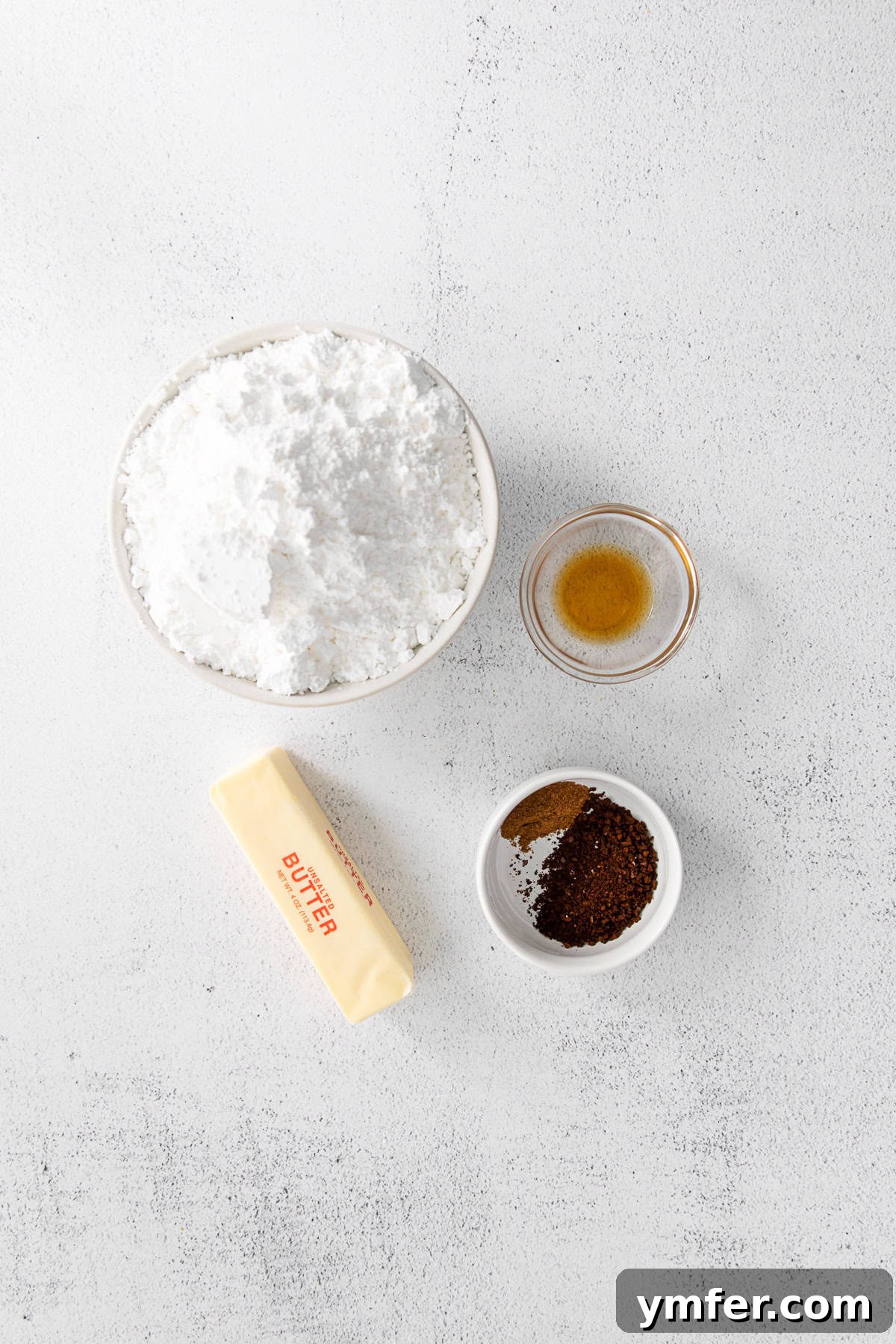 Ingredients for making creamy espresso and pumpkin spice buttercream frosting laid out neatly.