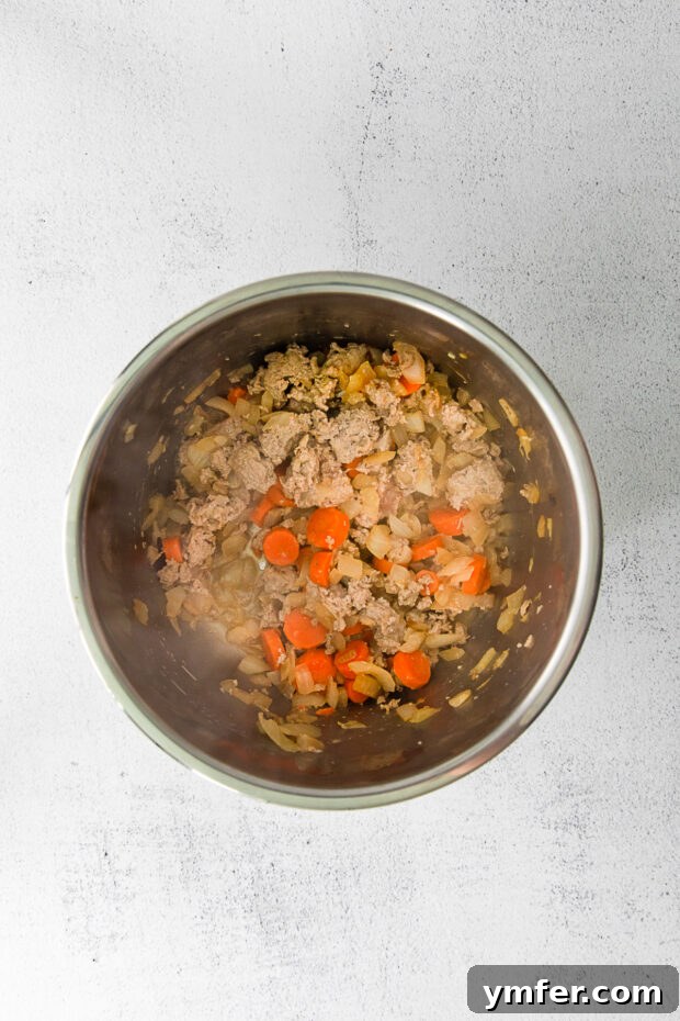 Hearty Instant Pot Turkey Chili 4 Close-up of chopped carrots and onions ready for sautéing in an Instant Pot.