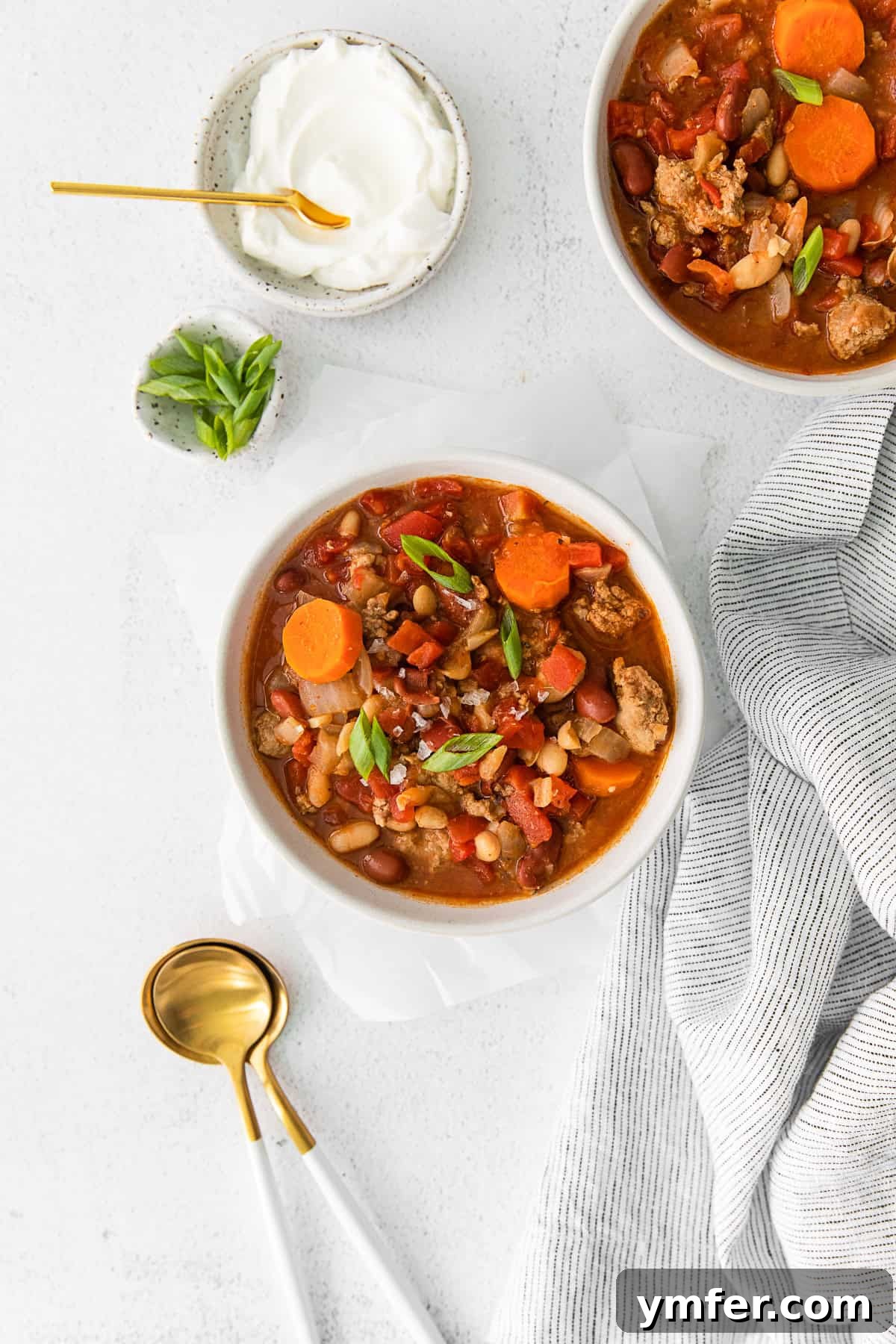 Hearty Instant Pot Turkey Chili 8 Various colorful fresh bell peppers and chili peppers on a wooden cutting board.