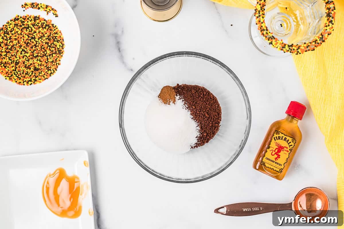 Fiery Froth Coffee 3 Two glasses of Fireball Whipped Coffee, one garnished with caramel drizzle and sprinkles, set on a rustic wooden surface with autumn leaves.