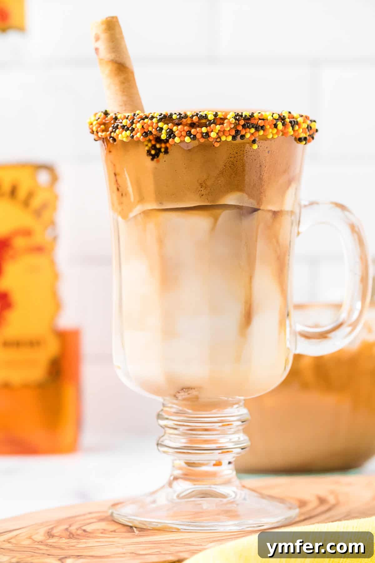 Fiery Froth Coffee 5 A Fireball Whipped Coffee drink in a tall glass, garnished with a generous amount of whipped coffee foam and a light dusting of cinnamon.