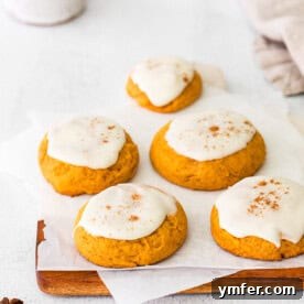 Cozy Fall Pumpkin Cookies 9 A delicious Soft Pumpkin Cookie with a generous layer of cream cheese frosting, ready to be enjoyed.