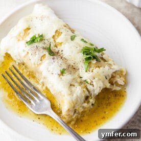Zesty Salsa Verde Chicken Enchiladas 10 Salsa Verde Chicken Enchiladas served on a plate with a fork.