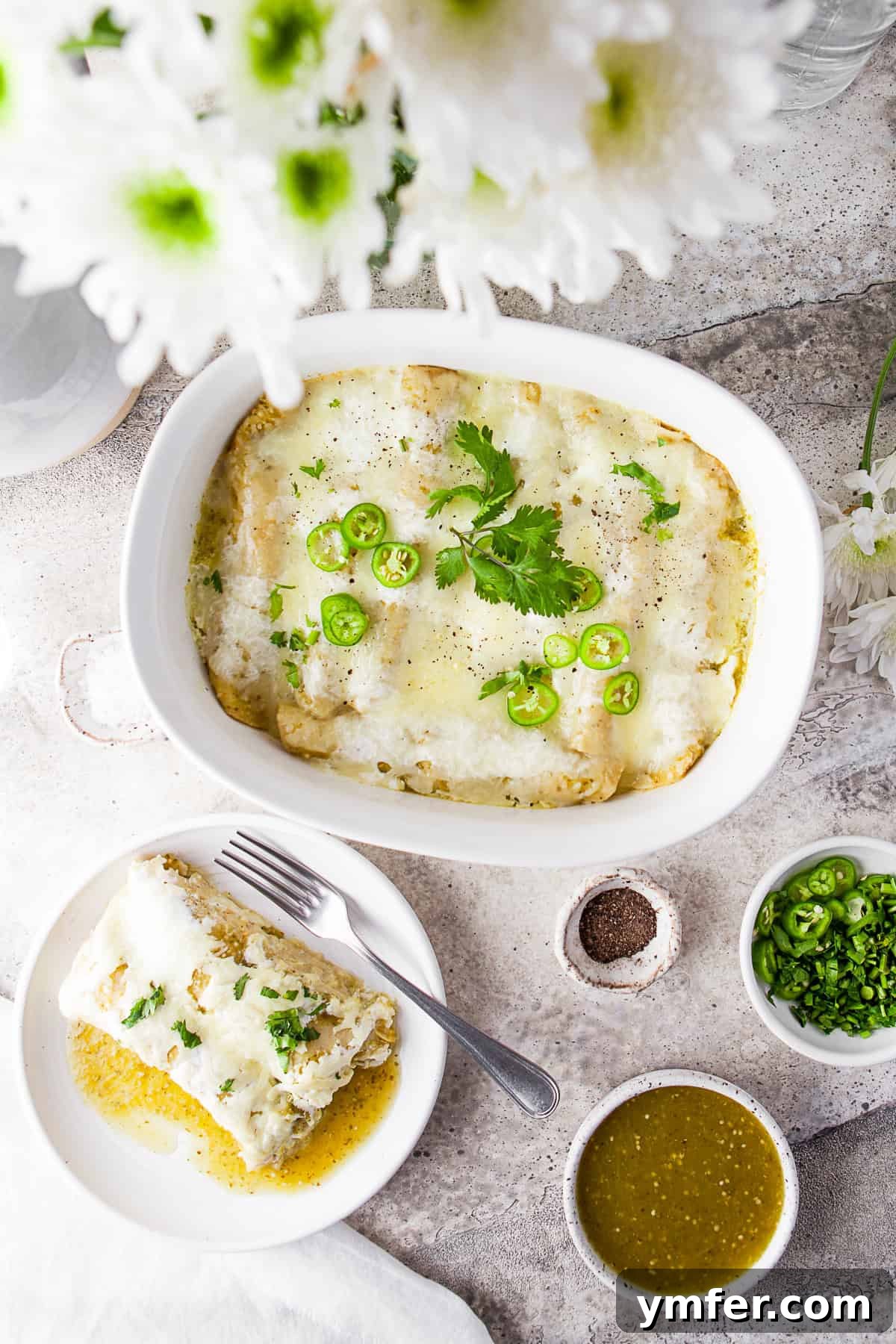 Zesty Salsa Verde Chicken Enchiladas 8 A large casserole dish filled with bubbling Salsa Verde Chicken Enchiladas, alongside a single enchilada served on a plate, garnished with fresh cilantro, ready to be enjoyed.
