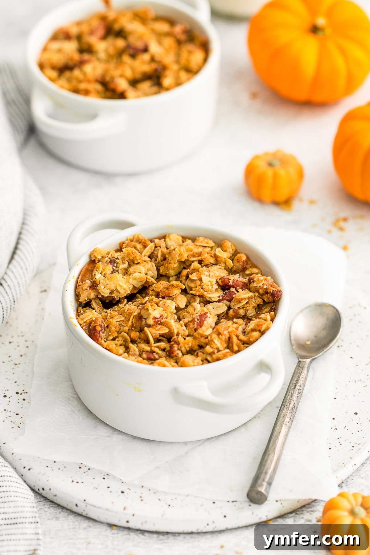 Pumpkin Crisp in a ramekin with a spoon.