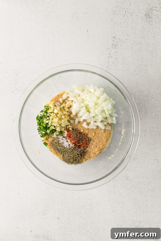 Smoky BBQ Glazed Meatloaf 4 Ground beef and other meatloaf ingredients in a large mixing bowl, ready to be combined.