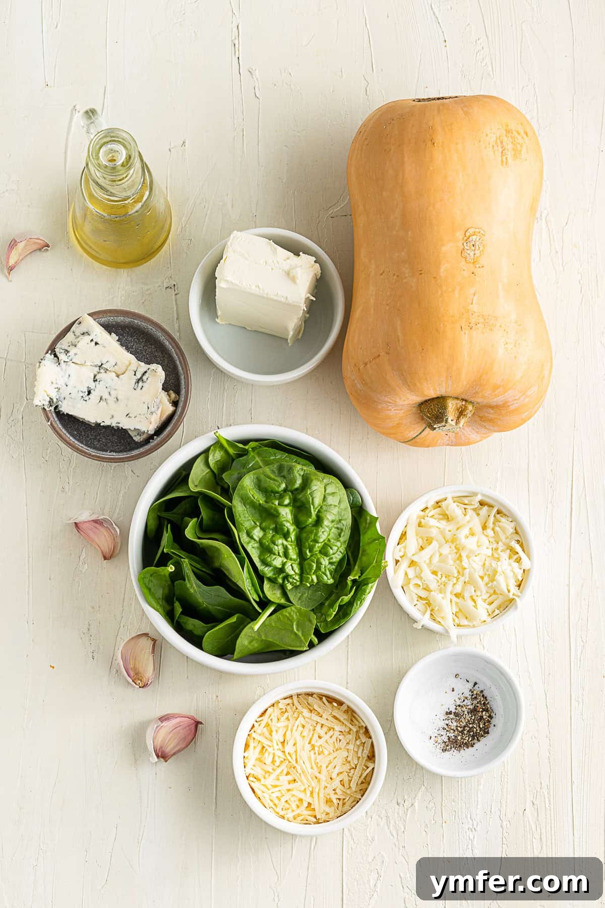 Creamy Cheesy Butternut Squash Bake 3 Ingredients for making Cheese Stuffed Butternut Squash laid out on a kitchen table.