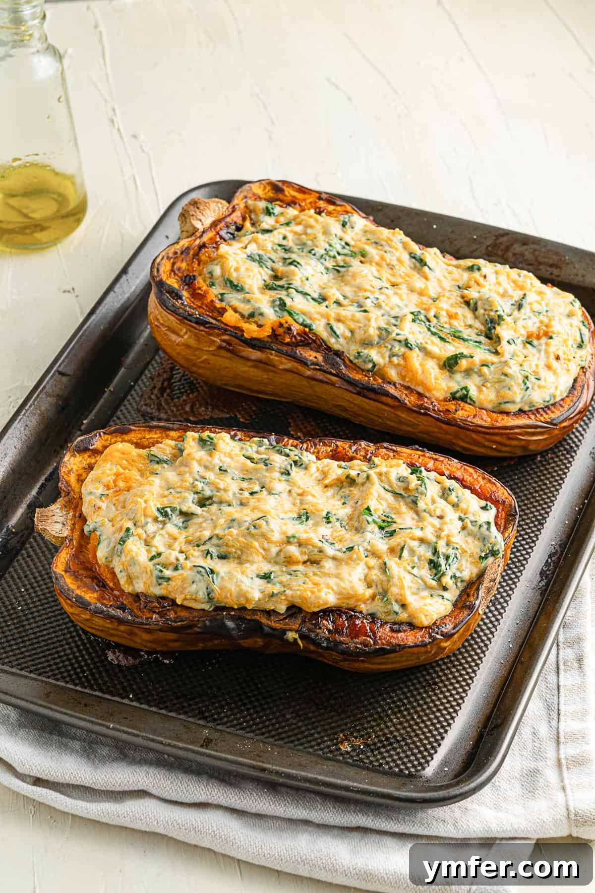 Creamy Cheesy Butternut Squash Bake 6 Close-up of a butternut squash half generously stuffed with the four-cheese and spinach filling, ready for its final bake.