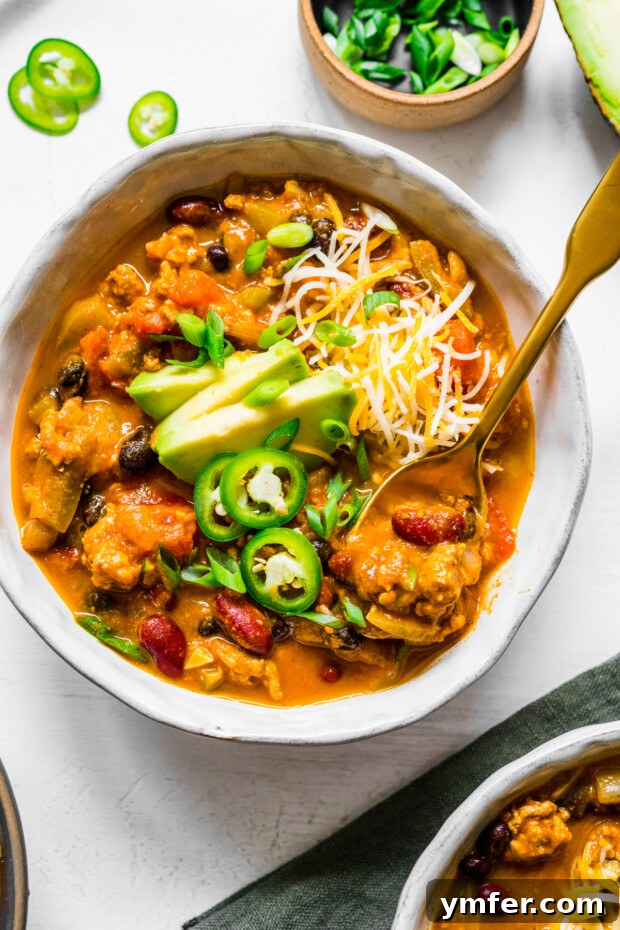 A comforting bowl of Turkey Pumpkin Chili, perfect for cool winter months and a non-traditional, hearty Thanksgiving alternative.