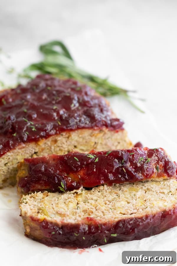 A delicious Thanksgiving turkey meatloaf topped with sweet whole cranberry sauce, a perfect non-traditional holiday main dish.