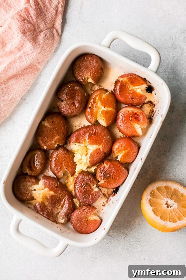 Golden Gooey Smashed Potatoes 6 A baking dish filled with tender, smashed baby red potatoes before cheese is added.