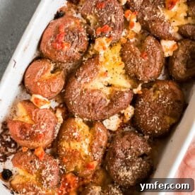 Cheesy Smashed Potatoes recipe card image.